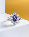 1.5 Carat Oval Cut 5A Rated Sapphire Blue Cubic Zirconia Fancy Halo Engagement Ring in Platinum Plated Sterling Silver - Boutique Pavè