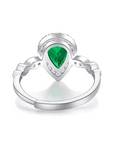 1.5 Carat Pear Cut Emerald Cut Lab Created Emerald and Moissanite Halo Engagement Ring in 14 Karat White Gold - Boutique Pavè