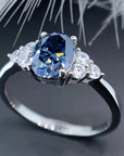 1.5 Total Carat Oval Cut Vivid Blue Moissanite Accent Solitaire Engagement Ring in 18 Karat White Gold - Boutique Pavè