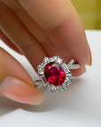 2 Carat Oval Cut Ruby Red Cubic Zirconia Fancy Halo Engagement Ring in Platinum Plated Sterling Silver - Boutique Pavè