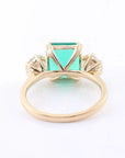 4 Carat Emerald Cut Lab Created Emerald and Round Moissanite Accent Engagement Ring in 14 Karat Yellow Gold - Boutique Pavè
