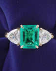 4 Carat Emerald Cut Lab Created Emerald and Trillion Cut Moissanite Accent Engagement Ring in 14 Karat Yellow Gold - Boutique Pavè