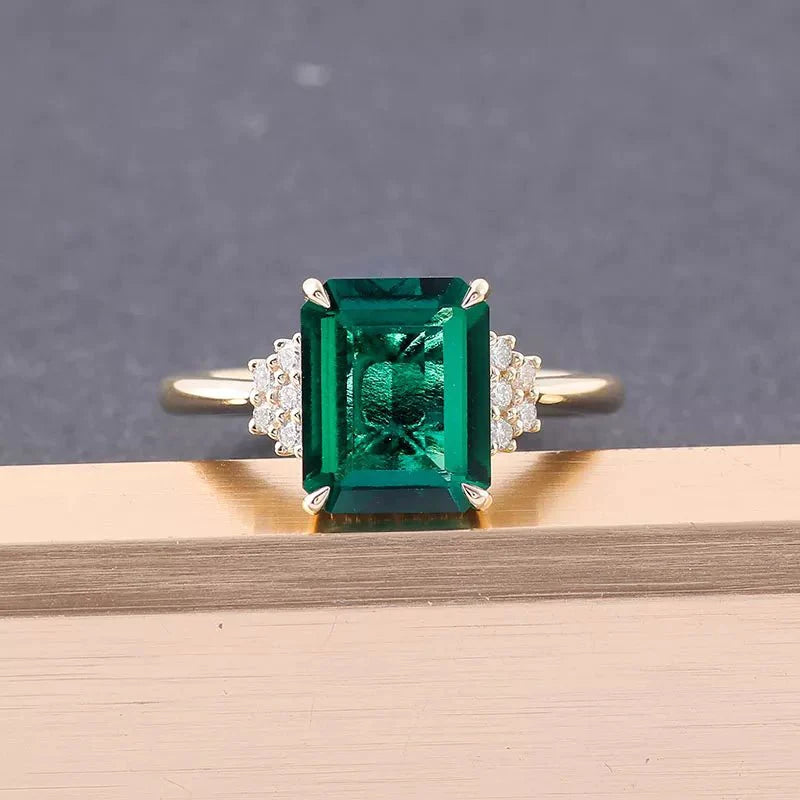 Four Carat Emerald Cut Lab Created Emerald Moissanite Accent Engagement Ring in 10 Karat Yellow Gold - Boutique Pavè