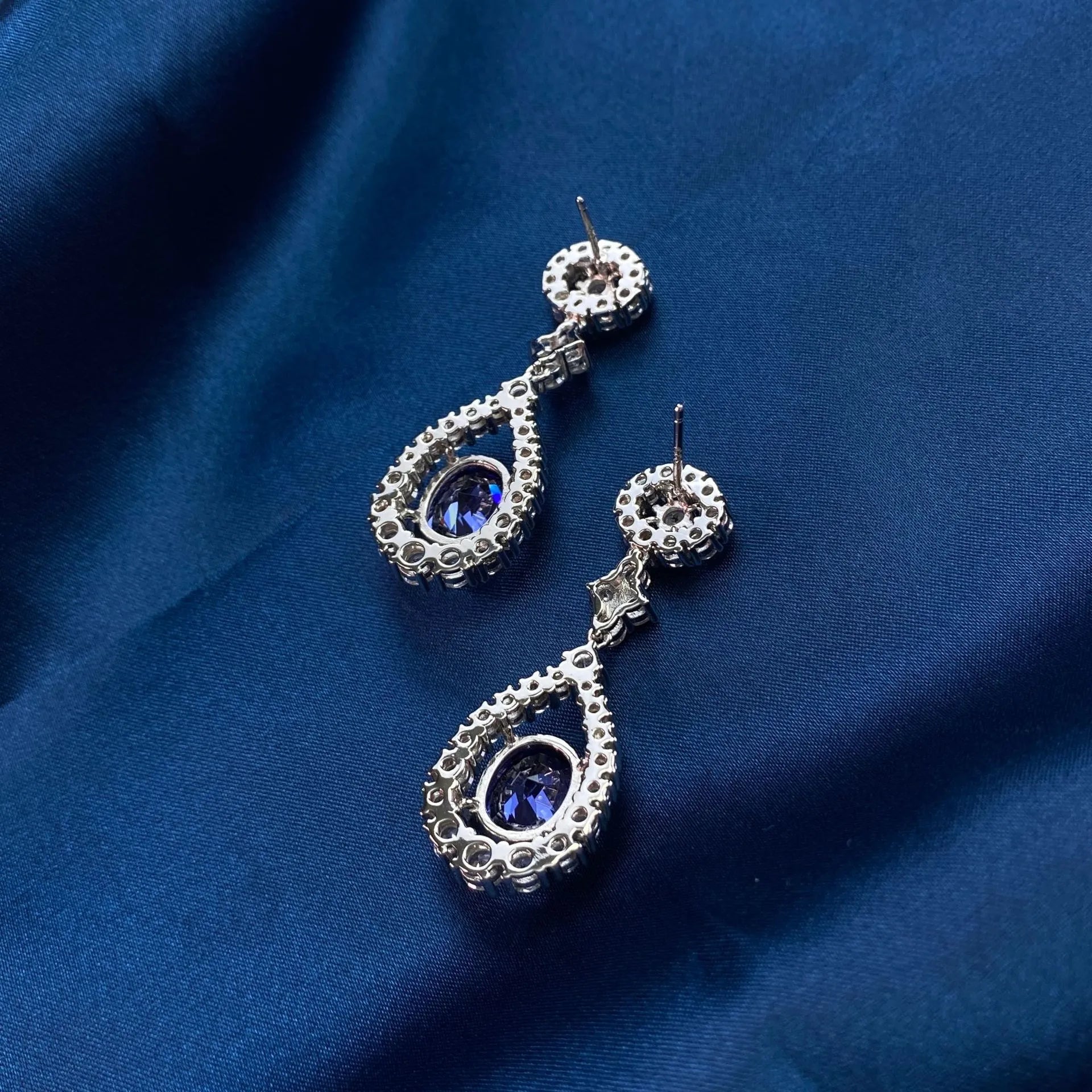 Four Carat Oval Cut Imitation Tanzanite and Cubic Zirconia Statement Earrings in Platinum-Plated Sterling Silver - Boutique Pavè