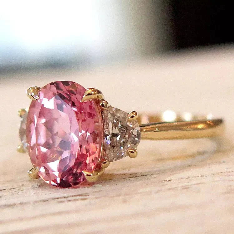 Four Carat Oval Cut Lab Created Pink Sapphire and Moissanite Accent Engagement Ring in 10 Karat Yellow Gold - Boutique Pavè