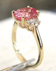 Four Carat Oval Cut Lab Created Pink Sapphire and Moissanite Accent Engagement Ring in 10 Karat Yellow Gold - Boutique Pavè