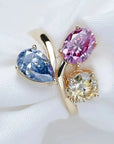 Four Carat Pear Round and Oval Fancy Color Three Stone Moissanite Ring in 18 Karat Yellow Gold - Boutique Pave