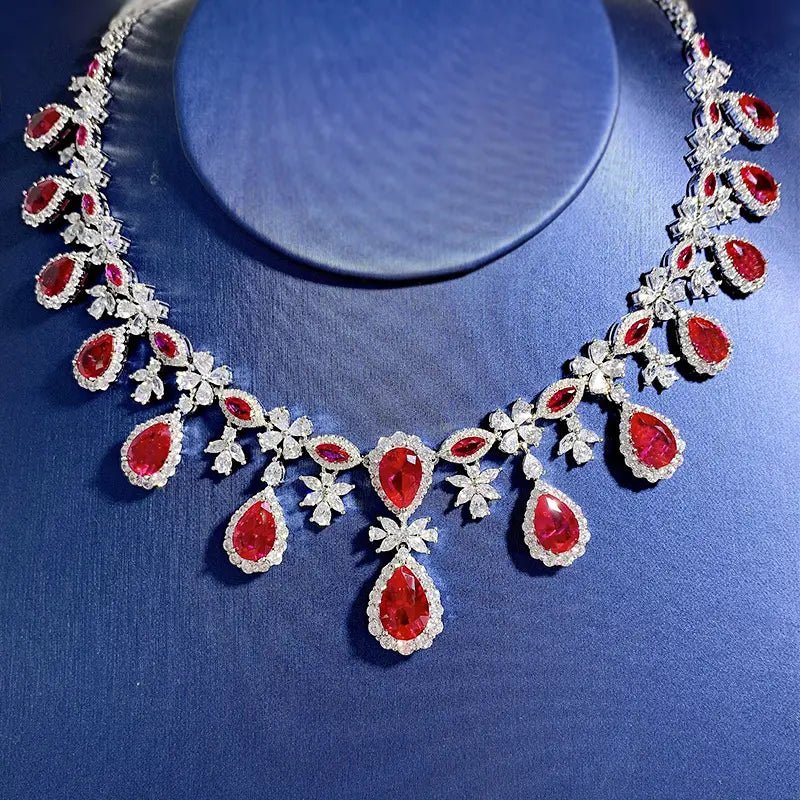 Glamourous Pear and Round Cut Imitation Ruby and Cubic Zirconia Statement Necklace in Platinum-Plated Sterling Silver - Boutique Pavè
