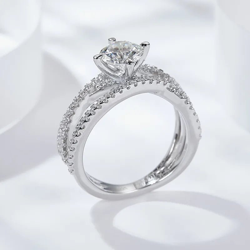 One Carat Brilliant Round Cut Moissanite Cross Over Pave Solitaire Engagement Ring in Platinum Plated Sterling Silver - Boutique Pavè