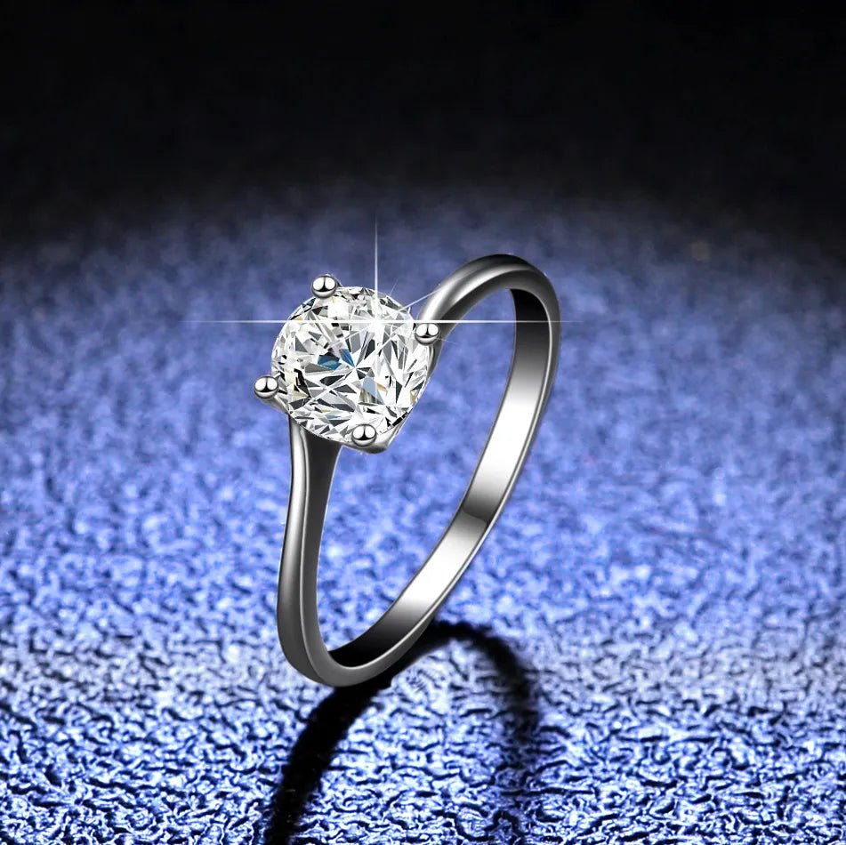 One Carat Brilliant Round Cut Moissanite Heart V Prong Solitaire Engagement Ring in Platinum Plated Sterling Silver - Boutique Pavè