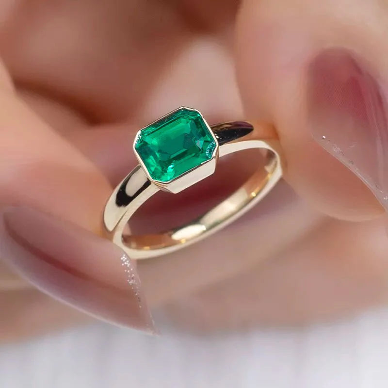 One Carat Emerald Cut Lab Created Emerald Gemstone Tension Set Ring in 18 Karat Yellow Gold - Boutique Pavè