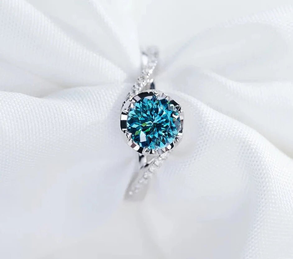 One Carat Round Cut Vivid Blue Moissanite Pave Twisted Engagement Ring in 18 Karat White Gold - Boutique Pavè