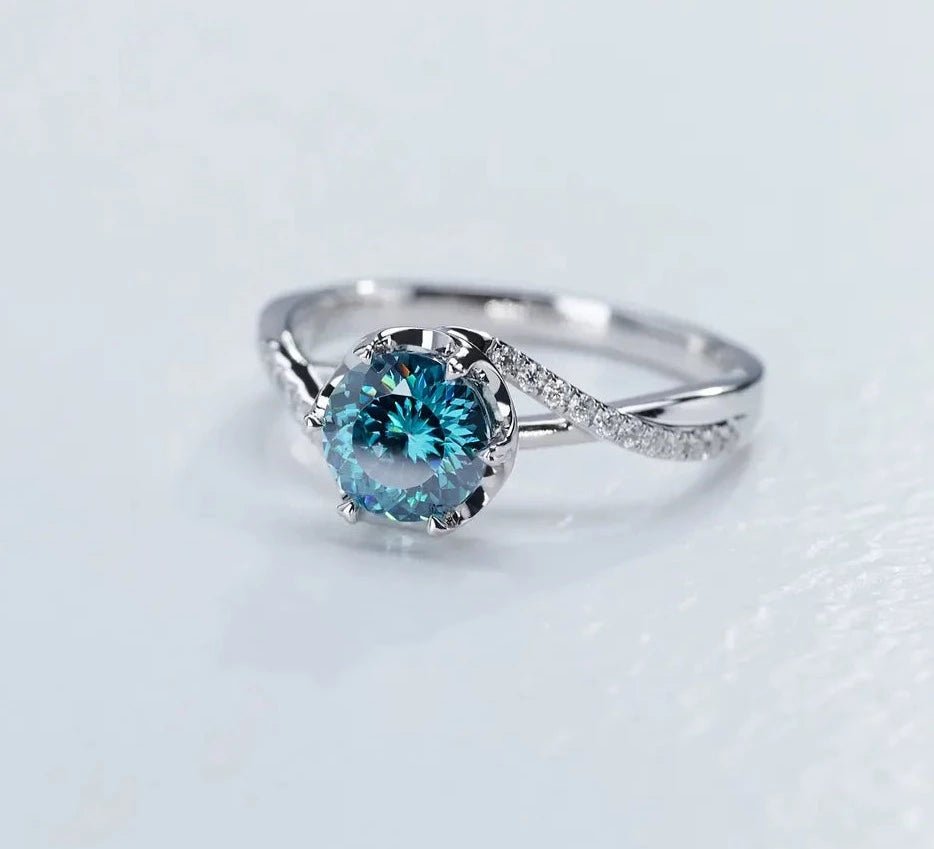 One Carat Round Cut Vivid Blue Moissanite Pave Twisted Engagement Ring in 18 Karat White Gold - Boutique Pavè
