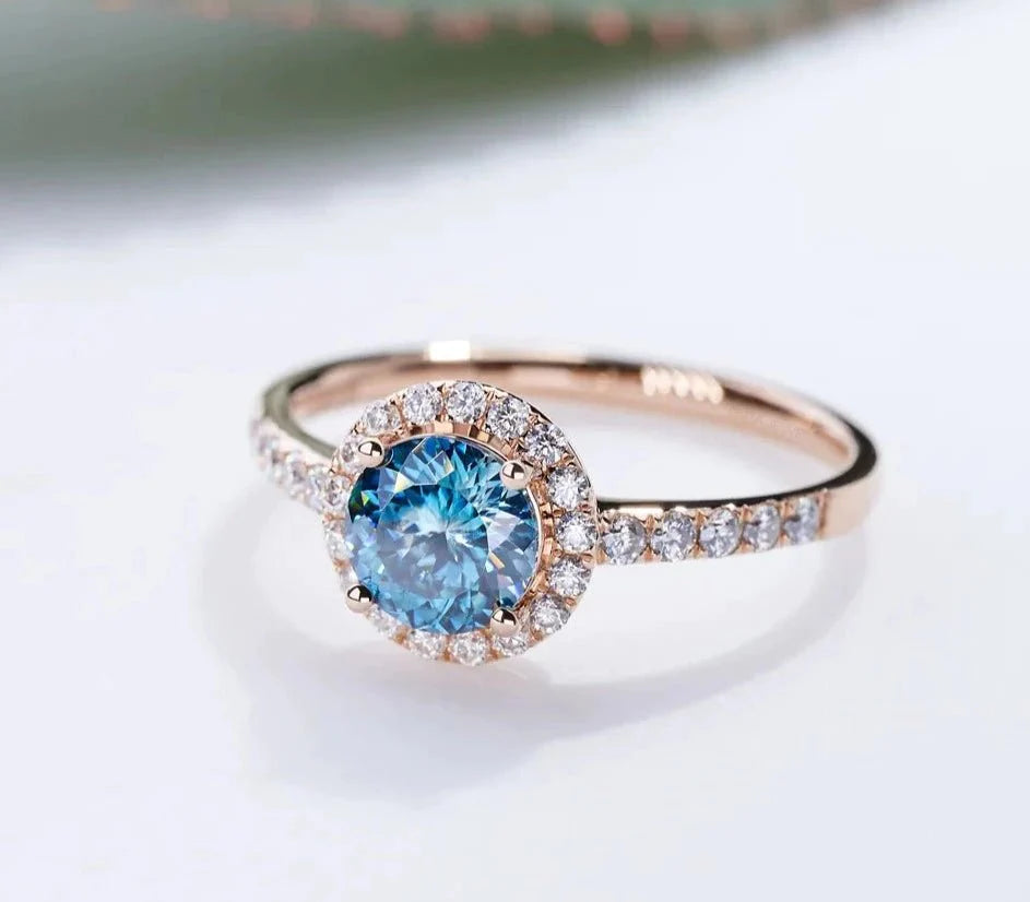 One Carat Round Portuguese Cut Blue Moissanite Halo Engagement Ring in 18 Karat Rose Gold - Boutique Pave