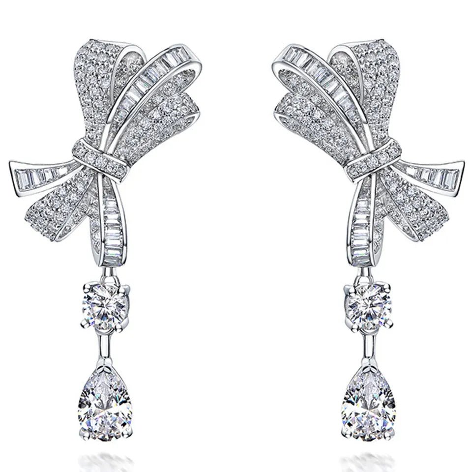 Pear and Round Cut Cubic Zirconia Drop Bow Tie Bridal Earrings in Platinum-Plated Sterling Silver - Boutique Pavè