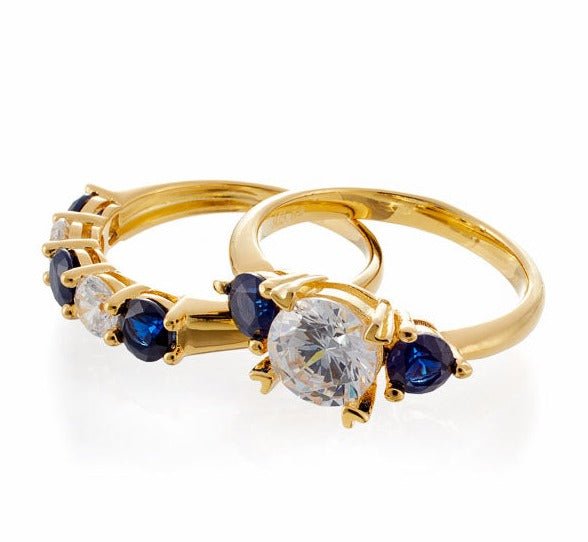 Round and Sapphire Blue Accent Cubic Zirconia Three Stone Bridal Set In Yellow Gold Plated Sterling Silver - Boutique Pavè