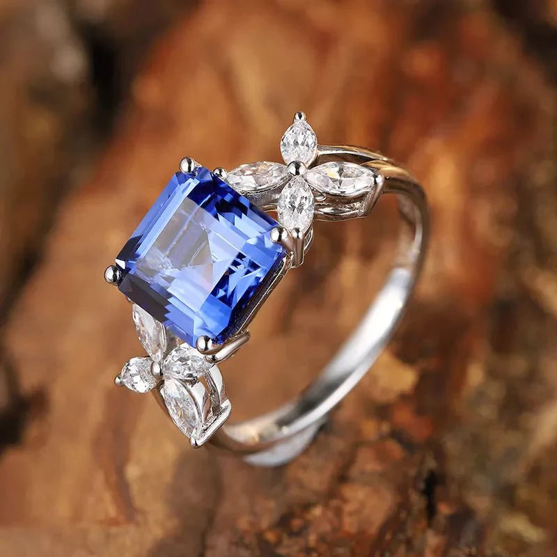 Two Carat Asscher Cut Lab Created Sapphire and CZ Engagement Ring in White Gold Plated Sterling Silver - Boutique Pavè
