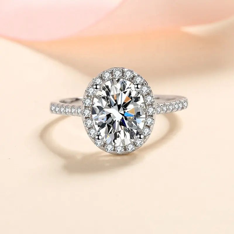 Two Carat Brilliant Oval Cut Moissanite Halo Engagement Ring in Platinum Plated Sterling Silver - Boutique Pavè