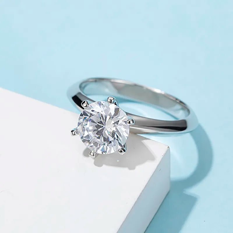 Two Carat Brilliant Round Cut Moissanite Solitaire Knife Edge Engagement Ring in Platinum Plated Sterling Silver - Boutique Pavè