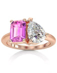 Two Carat Emerald and Pear Cut Moissanite and Lab Pink Sapphire Toi Et Moi Engagement Ring in 14 Karat Rose Gold - Boutique Pavè