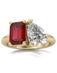Two Carat Emerald and Pear Cut Moissanite and Lab Ruby Toi Et Moi Engagement Ring in 14 Karat Yellow Gold - Boutique Pavè
