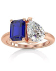 Two Carat Emerald Cut Lab Grown Blue Sapphire and Pear Cut White Moissanite Toi Et Moi Engagement Ring in 14 Karat Rose Gold - Boutique Pavè