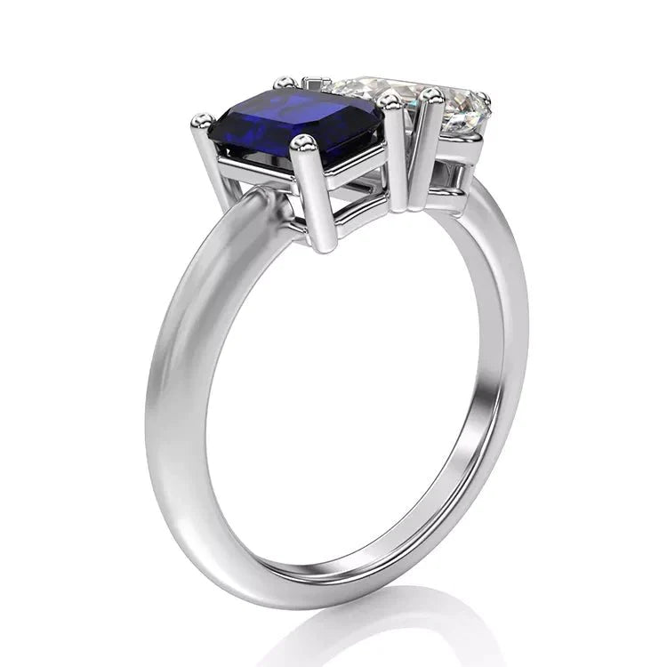 Two Carat Emerald Cut Lab Grown Blue Sapphire and Pear Cut White Moissanite Toi Et Moi Engagement Ring in 14 Karat White Gold - Boutique Pavè
