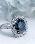 Two Carat Oval Cut Blue Moissanite Halo Engagement Ring in 18 Karat White Gold - Boutique Pave