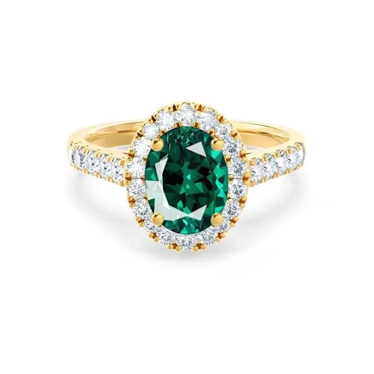 Two Carat Oval Cut Lab Created Emerald and Pave Moissanite Halo Engagement Ring in 18 Karat Yellow Gold - Boutique Pavè