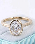 Two Carat Oval Cut Moissanite Bezel Tension Set Solitaire Engagement Ring in 14 Karat Yellow Gold - Boutique Pavè