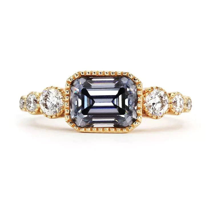 Vintage Inspired East West Two Carat Emerald Cut Gray Moissanite Engagement Ring in 10 Karat Yellow Gold - Boutique Pavè